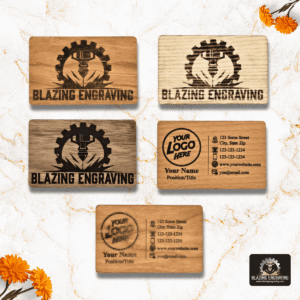 Assortment of custom laser-engraved wooden business cards from Blazing Engraving, featuring various wood tones and personalized designs with logos, names, and contact details, displayed on a marble background with orange flowers.