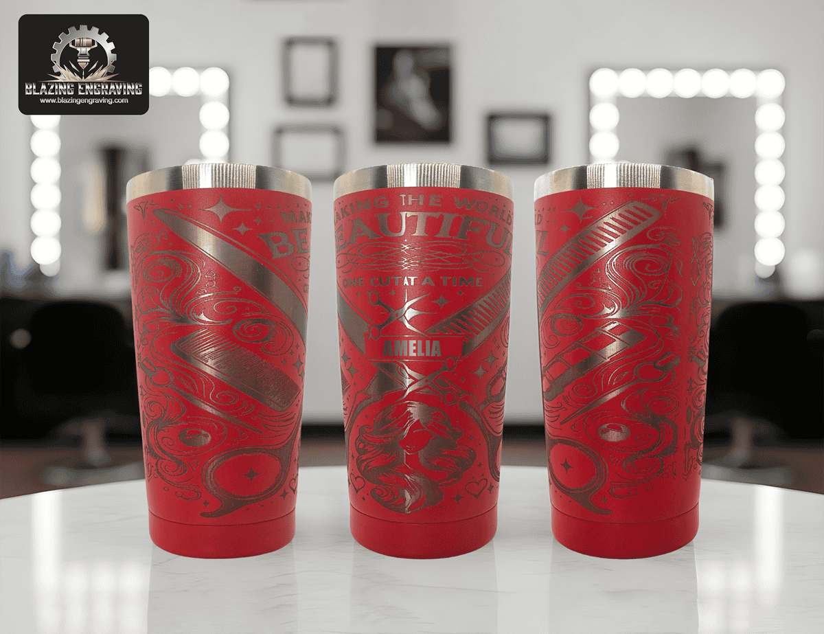 Three red stainless steel tumblers with silver laser-engraved barber-themed designs and the name ‘Amelia,’ displayed side by side to show the full design in a hair salon setting. Blazing Engraving logo in the top left corner.